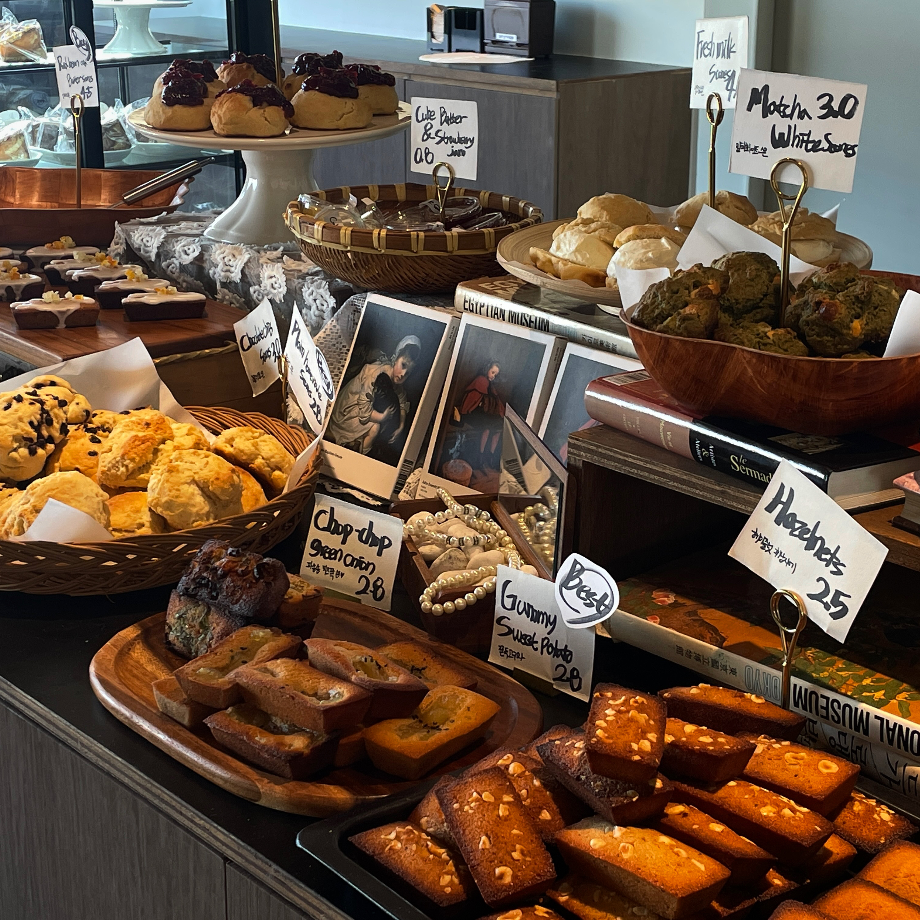 Fresh NOLSK financiers and scones displayed on wooden trays in the artisan bakery